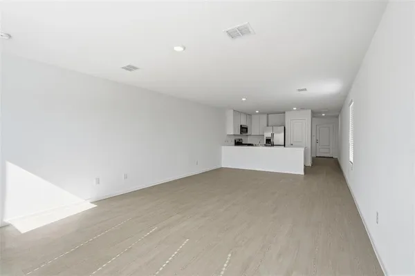a view of a livingroom with kitchen