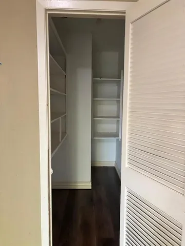 a view of closet area with empty racks
