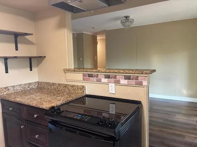 a stove top oven sitting inside of a kitchen