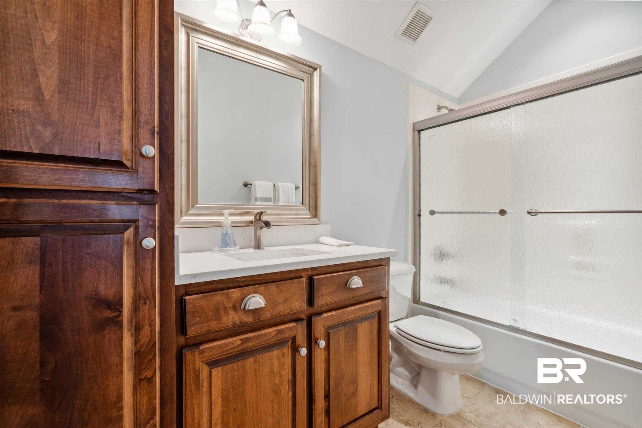 804 Country Club Road Mobile, AL 36609 - Photo 31 of 63 Full bathroom with vanity, tile patterned floors, shower / bath combination with glass door, toilet, and lofted ceiling