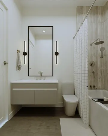 a bathroom with a tub a toilet and a sink