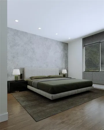 a spacious bedroom with a bed and window