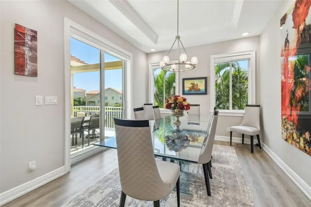 a view of a dining room with furniture wooden floor and chandelier