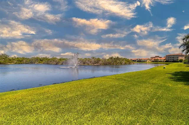 a view of a lake with houses in the back