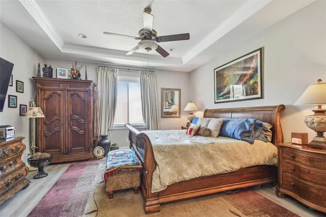 a bedroom with a bed and a chandelier