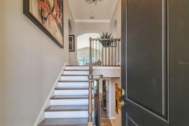 a view of entryway and hall with wooden floor