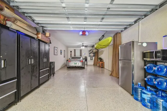 a kitchen with refrigerator and cabinets