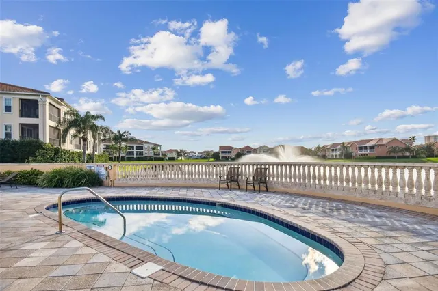 a view of swimming pool with seating space and wooden fence