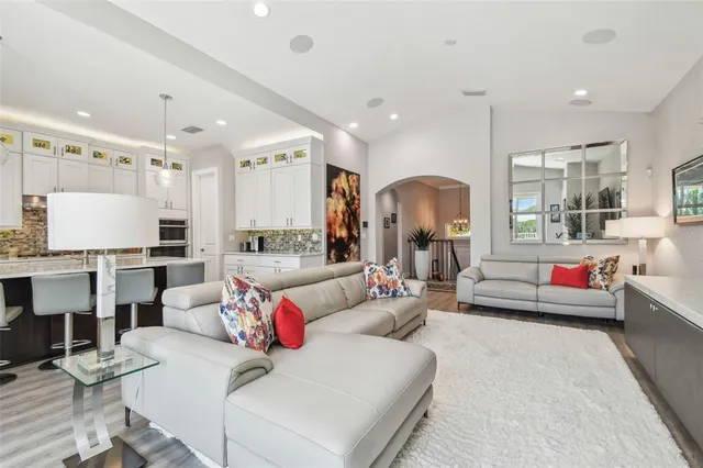 a living room with furniture and kitchen view