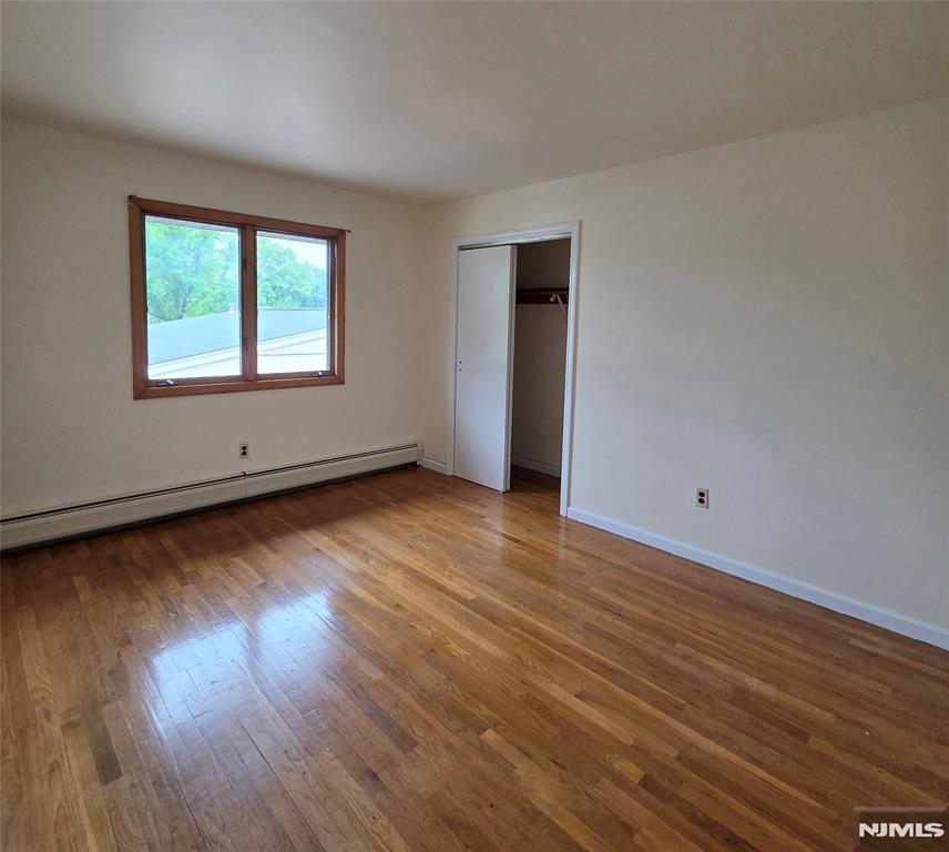 688 Day Avenue, Unit 2 Ridgefield, NJ 07657 - Photo 13 of 18 a view of an empty room with wooden floor and a window