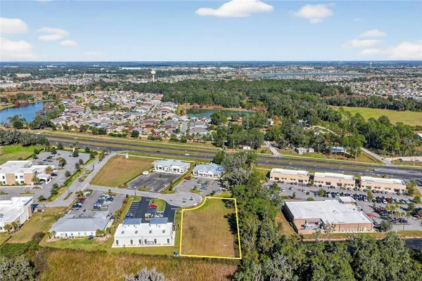 an aerial view of residential building and lake