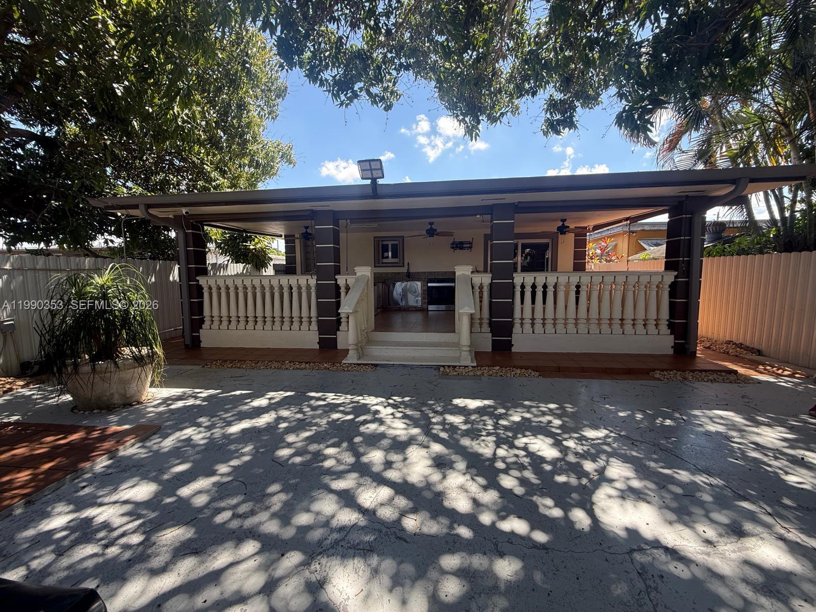 281 West 17th Street, Unit 281 Hialeah, FL 33010 - Photo 21 of 25 a view of a house with a small yard and wooden fence