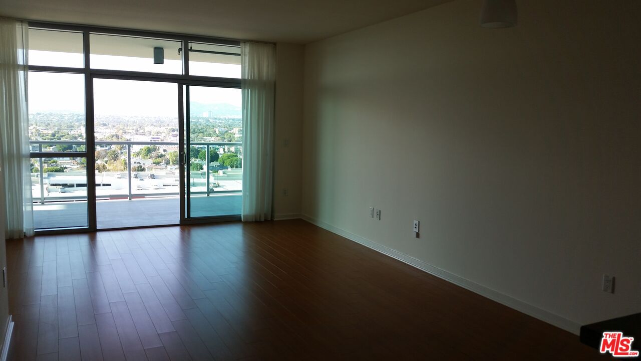13700 Marina Pointe Drive, Unit 1219 Marina del Rey, CA 90292 - Photo 11 of 48 a view of an empty room with wooden floor and a window