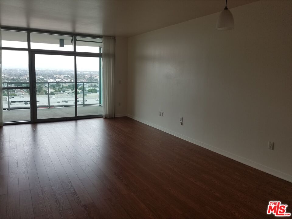 13700 Marina Pointe Drive, Unit 1219 Marina del Rey, CA 90292 - Photo 15 of 48 a view of an empty room with wooden floor and a window
