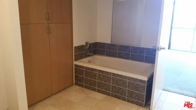 a bathroom with a bath tub and window