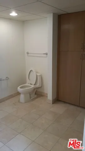 a bathroom with a toilet a sink and a mirror