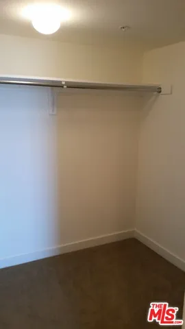 a white toilet sitting next to a white sink