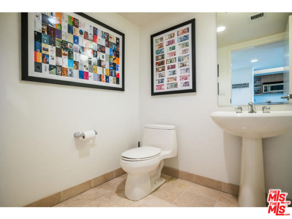 13700 Marina Pointe Drive, Unit 1219 Marina del Rey, CA 90292 - Photo 25 of 48 a bathroom with a toilet a sink and a mirror