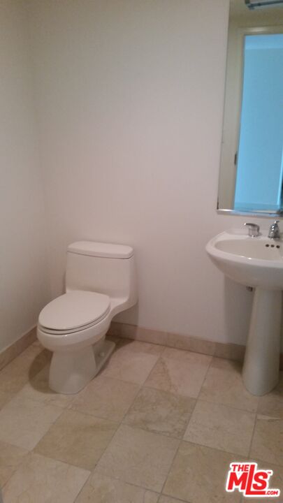 13700 Marina Pointe Drive, Unit 1219 Marina del Rey, CA 90292 - Photo 26 of 48 a white toilet sitting next to a white sink