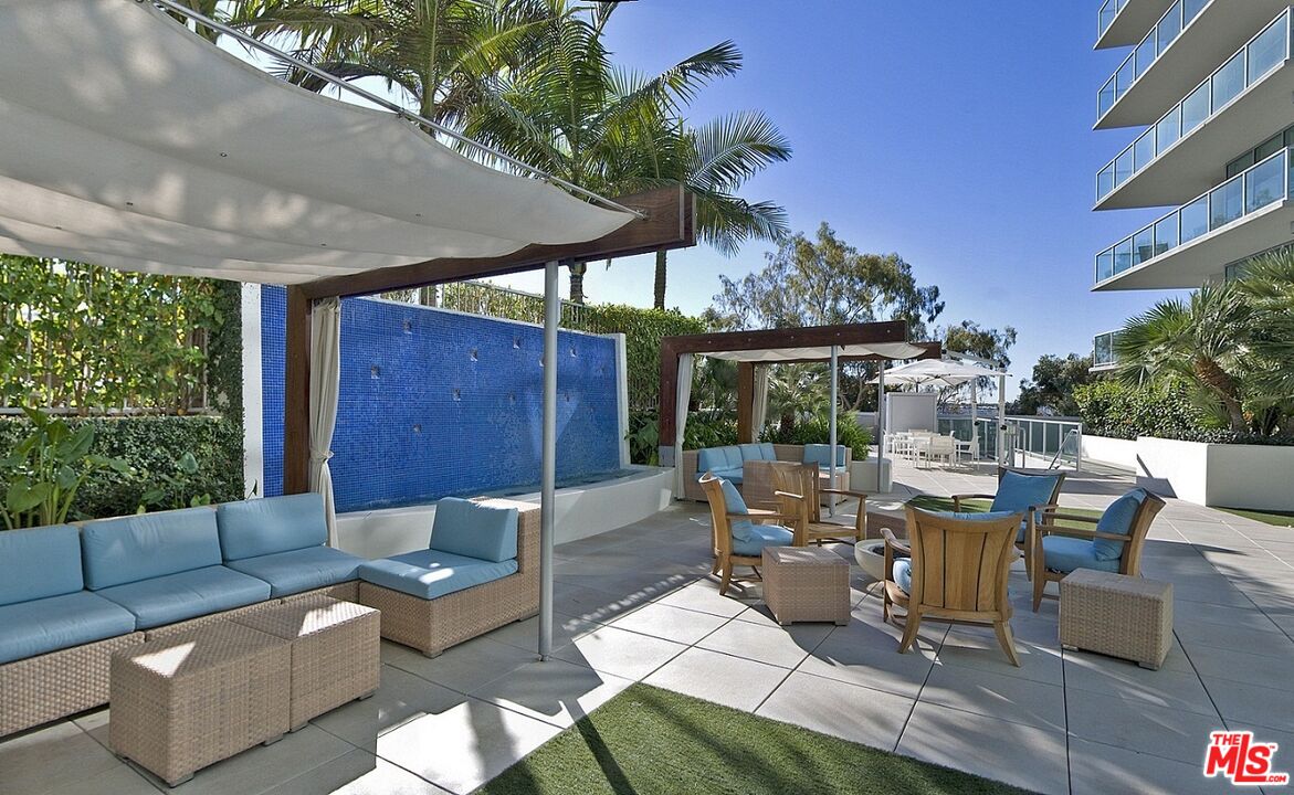 13700 Marina Pointe Drive, Unit 1219 Marina del Rey, CA 90292 - Photo 30 of 48 a view of a patio with couches and chairs under an umbrella with a patio