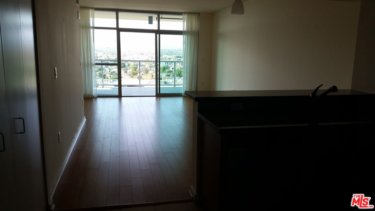 13700 Marina Pointe Drive, Unit 1219 Marina del Rey, CA 90292 - Photo 9 of 48 a view of a livingroom with wooden floor and a window