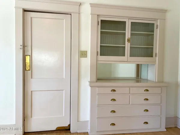 a view of a garden with plants and large trees