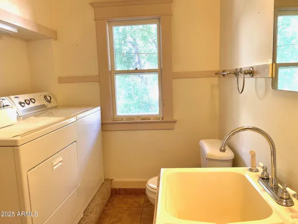 a bathroom with a sink mirror and tub