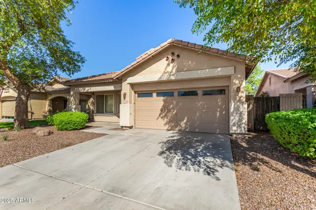 a front view of a house with a garden