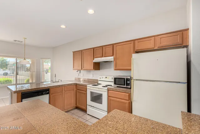 a kitchen with a sink appliances and cabinets
