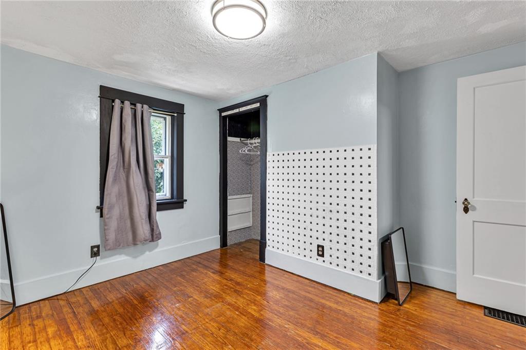 1201 5th Avenue Freedom, PA 15042 - Photo 22 of 32 an empty room with wooden floor and windows