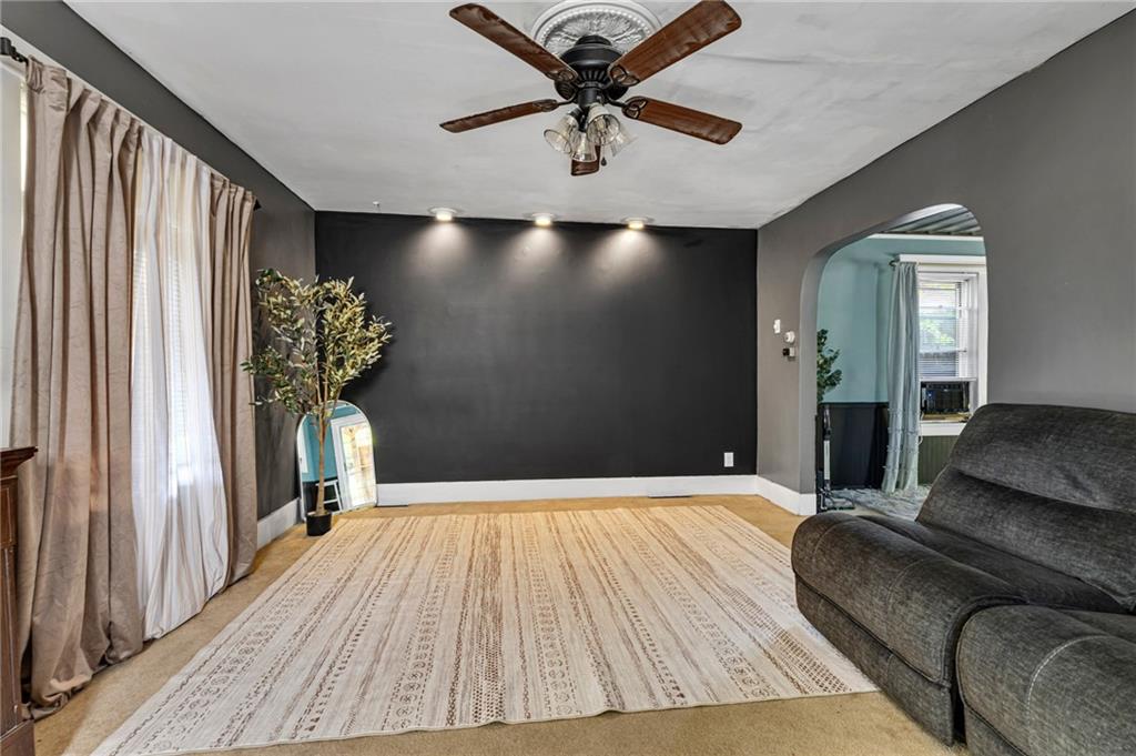 1201 5th Avenue Freedom, PA 15042 - Photo 5 of 32 a bedroom with a bed and a chandelier