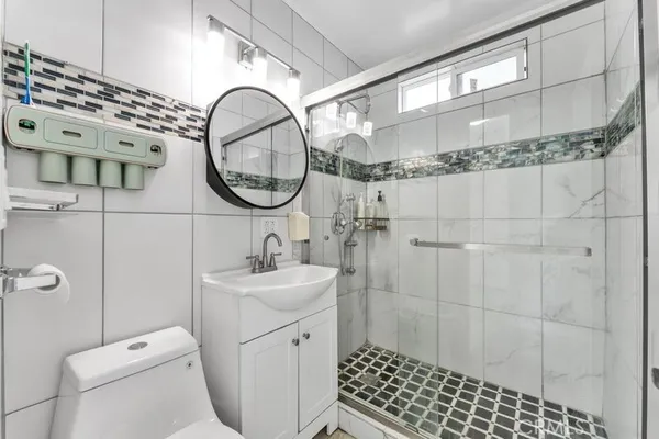a bathroom with a sink a toilet and a mirror