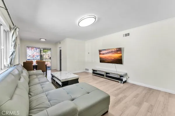 a living room with furniture gym equipment and a window