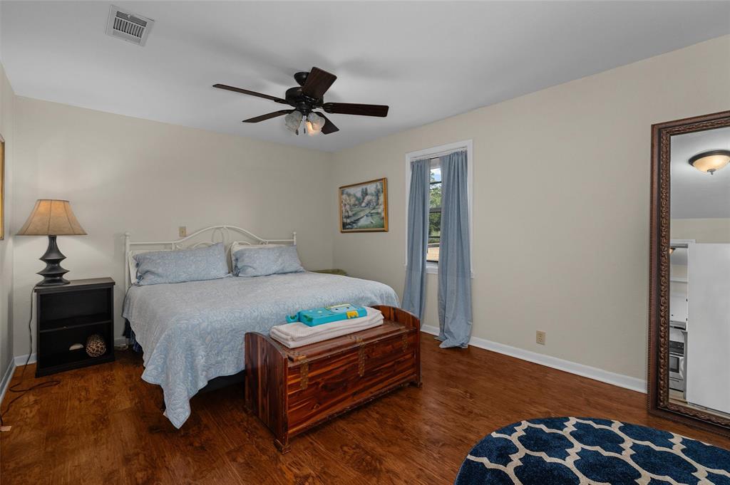 1131 Speights Road Keatchie, LA 71046 - Photo 27 of 33 Warm-toned wood-finish flooring, white walls, and a window with natural light