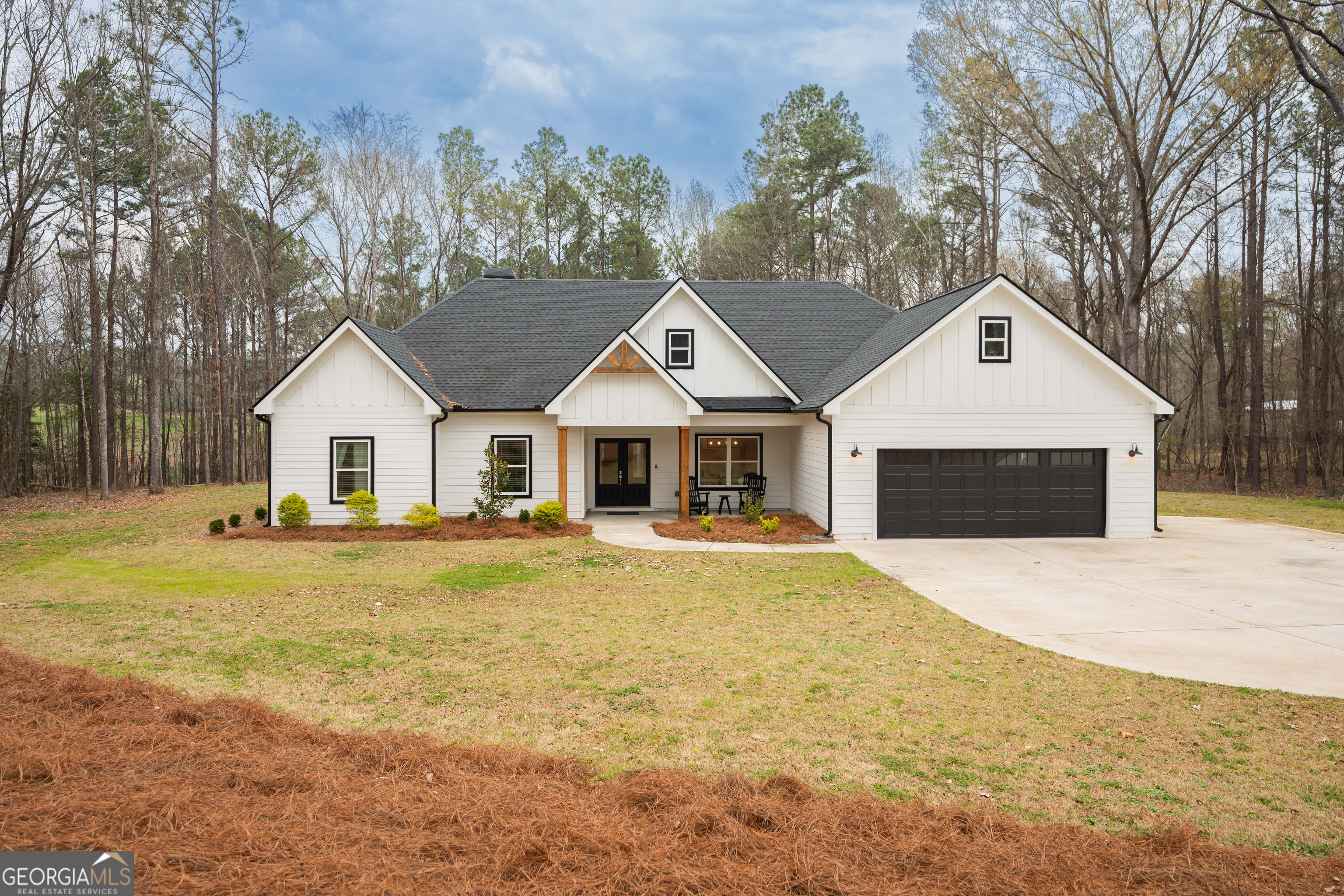 a front view of a house with yard and green space