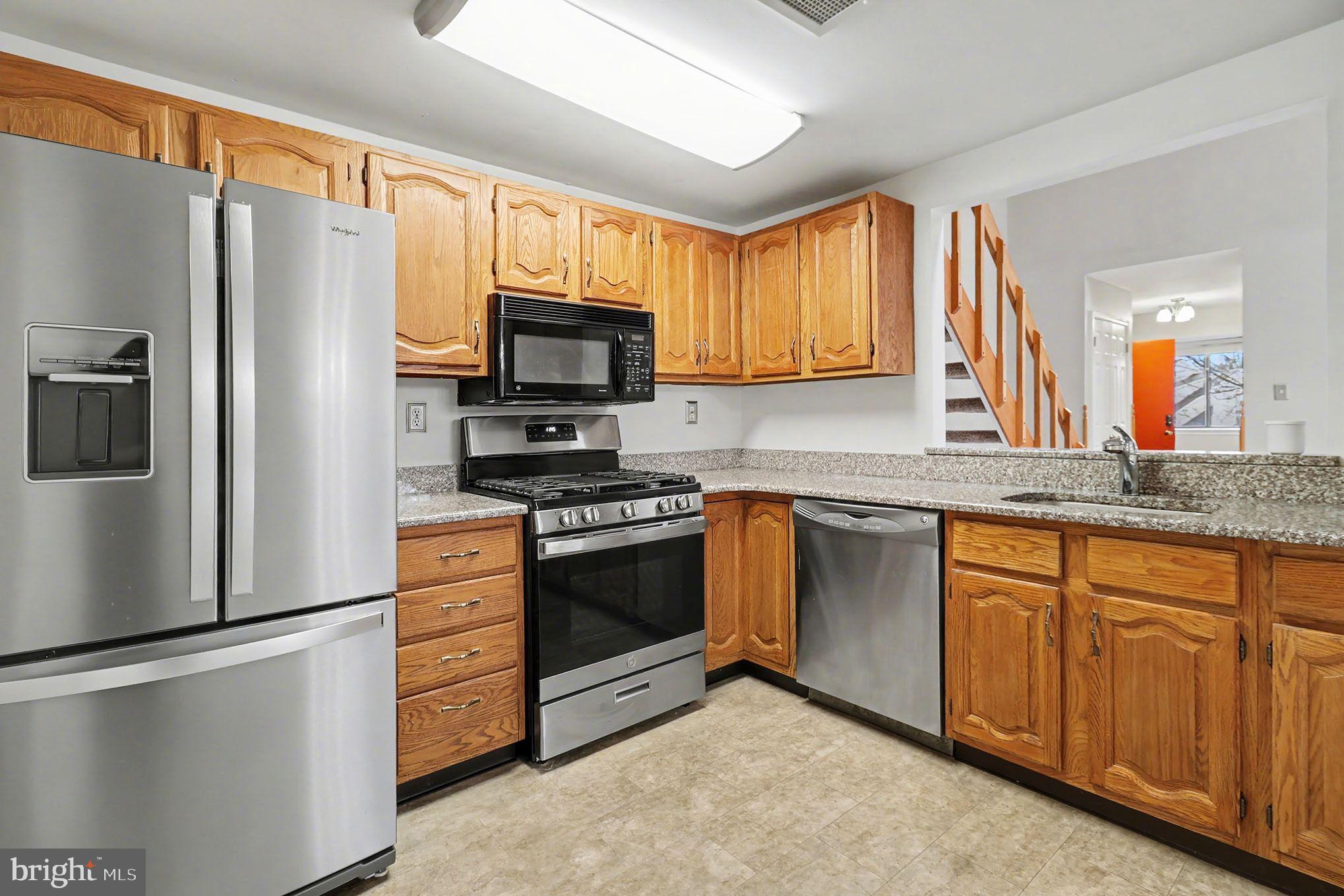 910 Mountainview Drive, Unit 910 Chesterbrook, PA 19087 - Photo 11 of 27 a kitchen with stainless steel appliances granite countertop a refrigerator stove microwave and sink