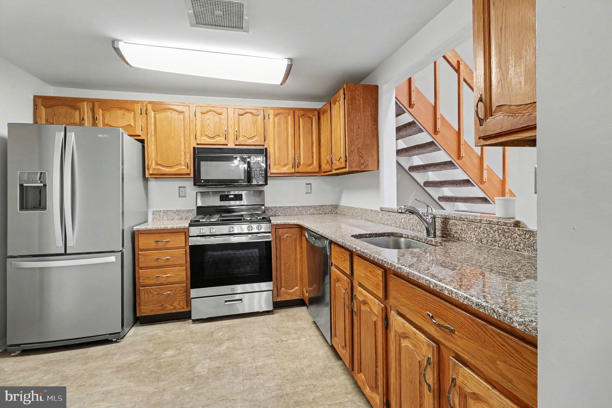 910 Mountainview Drive, Unit 910 Chesterbrook, PA 19087 - Photo 12 of 27 a kitchen with granite countertop a refrigerator stove and sink
