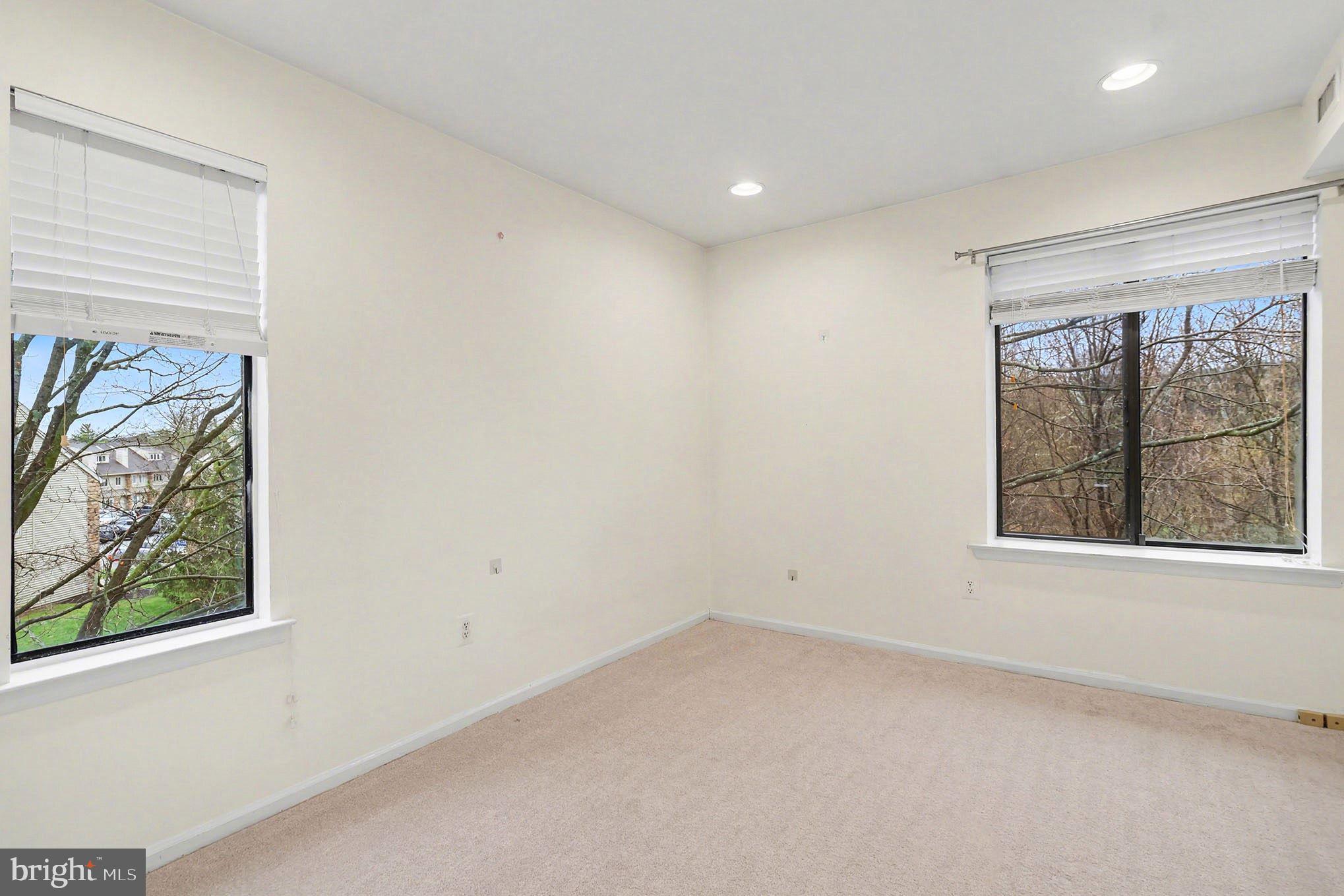 910 Mountainview Drive, Unit 910 Chesterbrook, PA 19087 - Photo 17 of 27 an empty room with windows