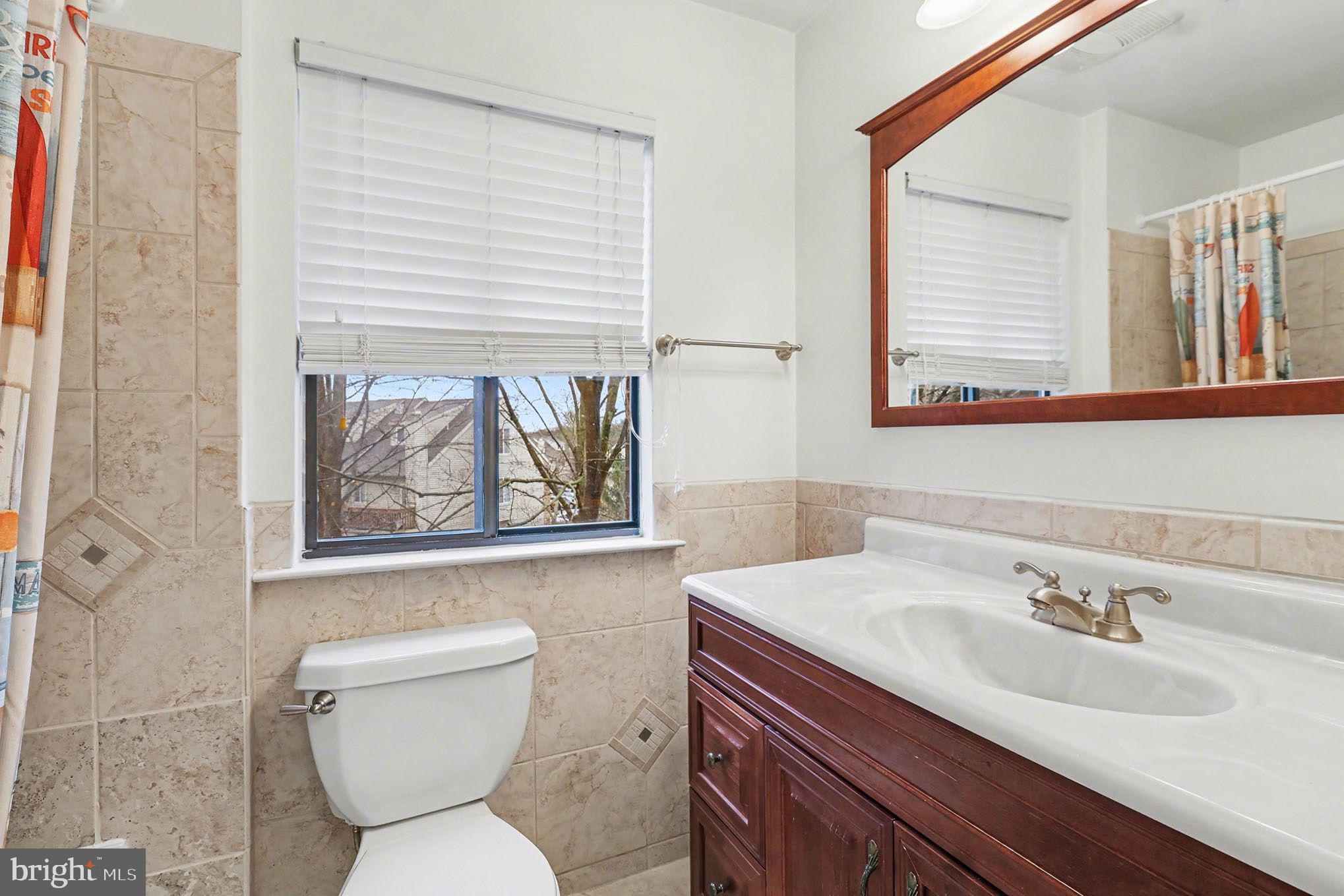 910 Mountainview Drive, Unit 910 Chesterbrook, PA 19087 - Photo 19 of 27 a bathroom with a toilet sink and mirror