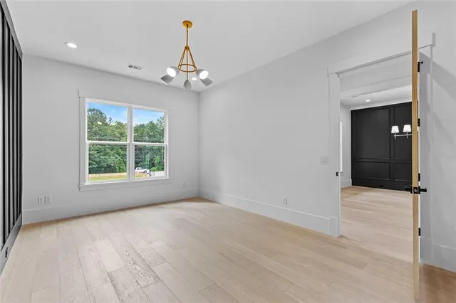 a view of walk in closet with empty racks
