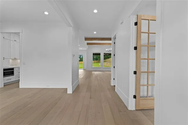 a view of an empty room with a ceiling fan window and a ceiling fan