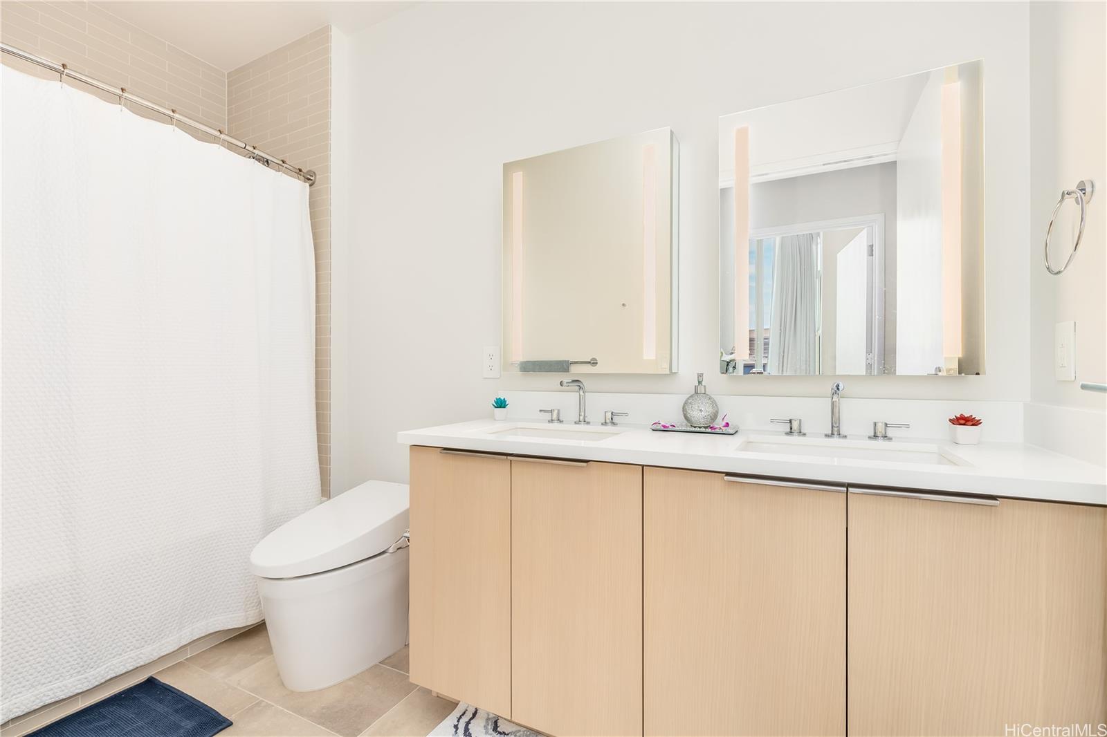 1001 Queen Street, Unit 3907 Honolulu, HI 96814 - Photo 12 of 25 a bathroom with a sink and a toilet