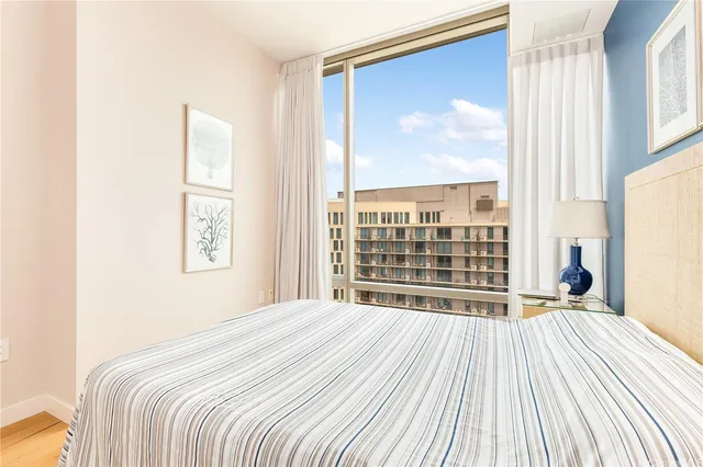 a bedroom with a bed and a large window