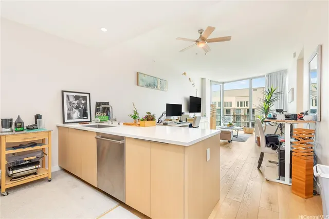 a living room with stainless steel appliances kitchen island furniture and a table