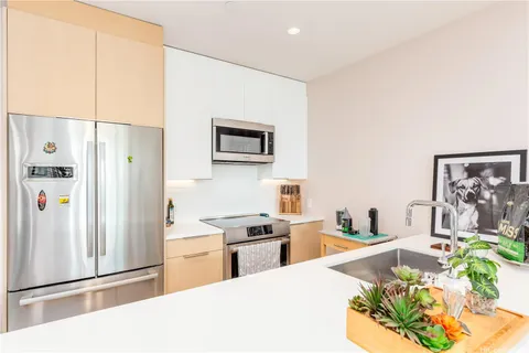 a kitchen with stainless steel appliances a refrigerator and a stove top oven