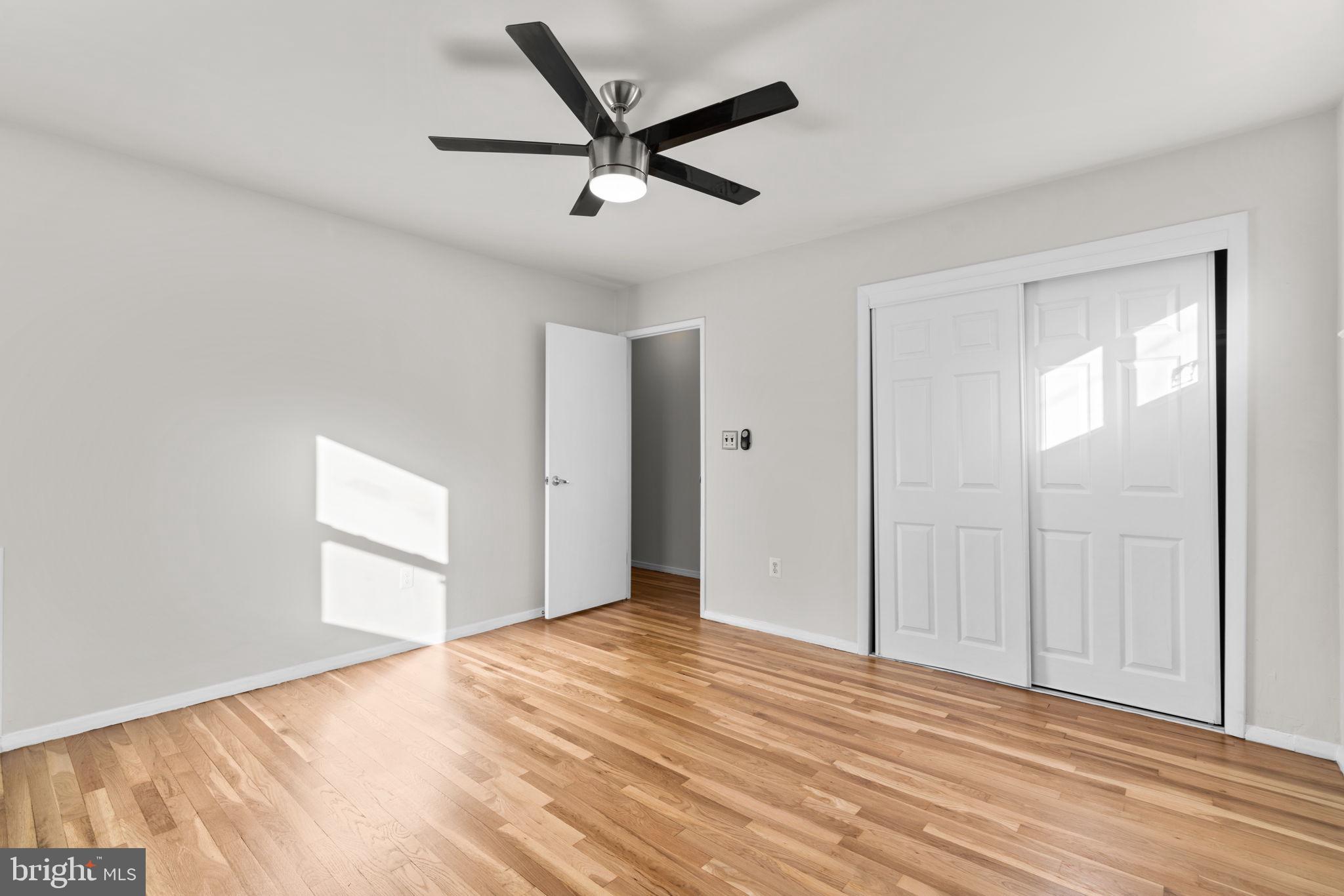 8111 Phirne Road East Glen Burnie, MD 21061 - Photo 15 of 30 a view of empty room with wooden floor and fan