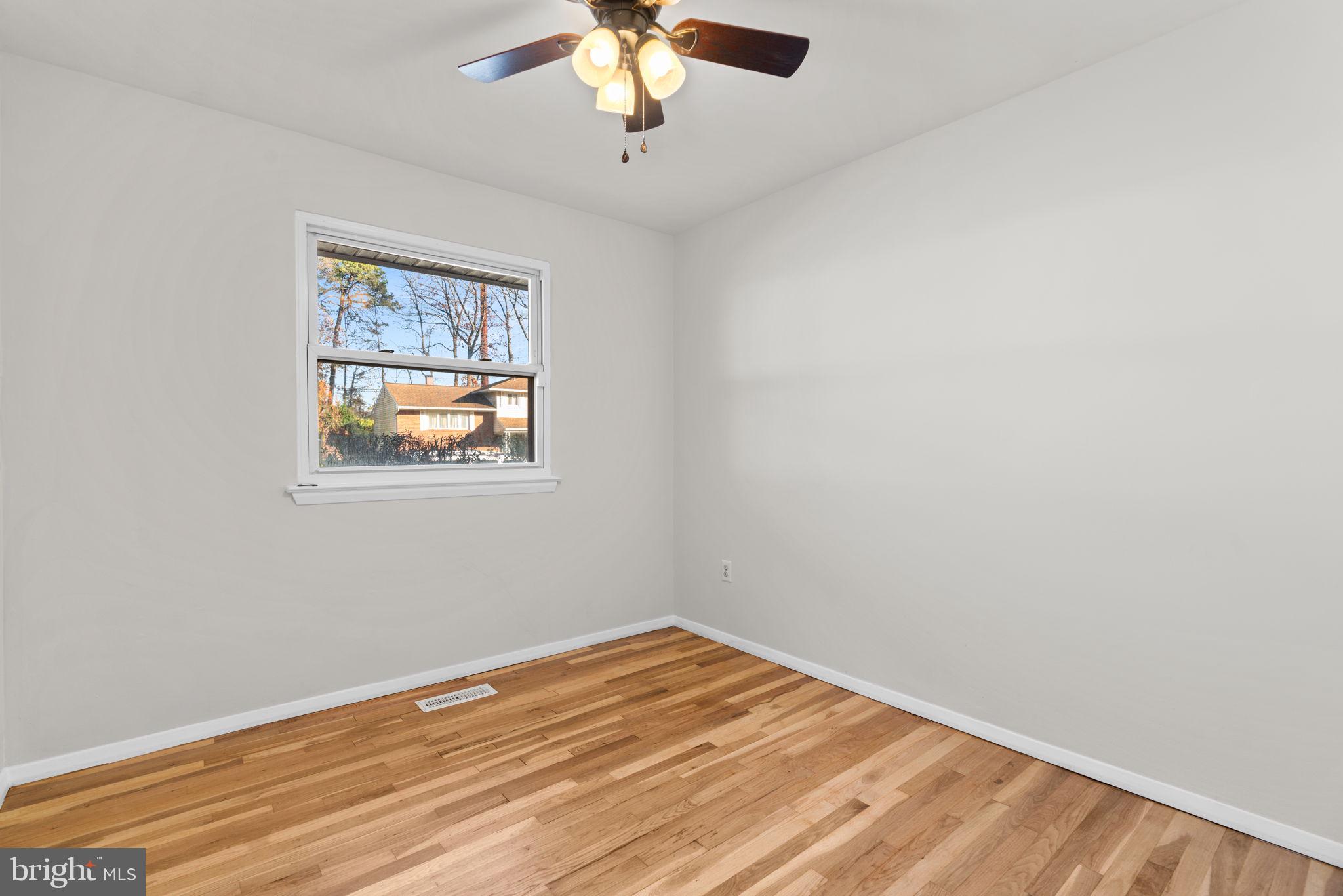 8111 Phirne Road East Glen Burnie, MD 21061 - Photo 17 of 30 an empty room with a window and ceiling fan