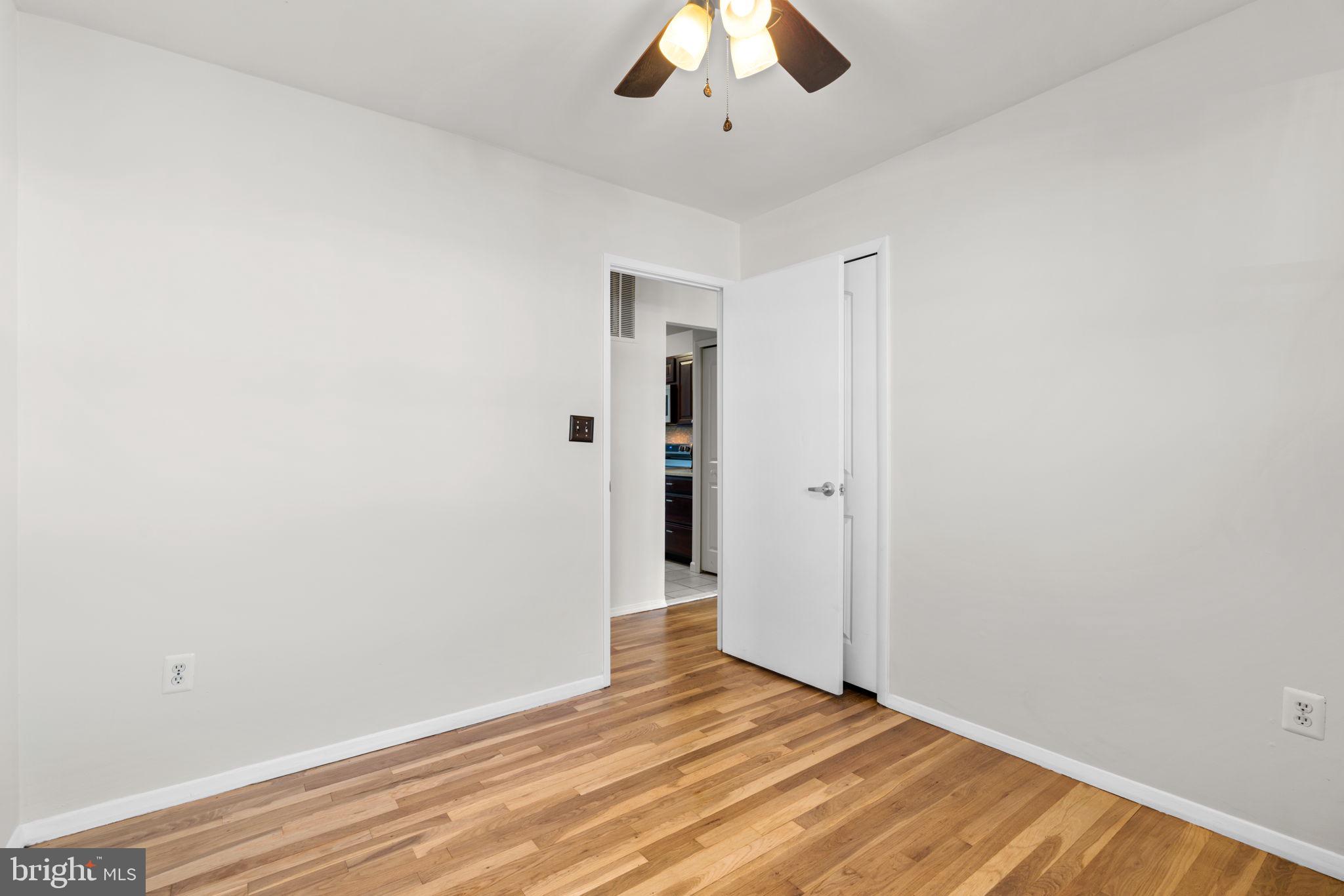 8111 Phirne Road East Glen Burnie, MD 21061 - Photo 18 of 30 a view of an empty room with wooden floor