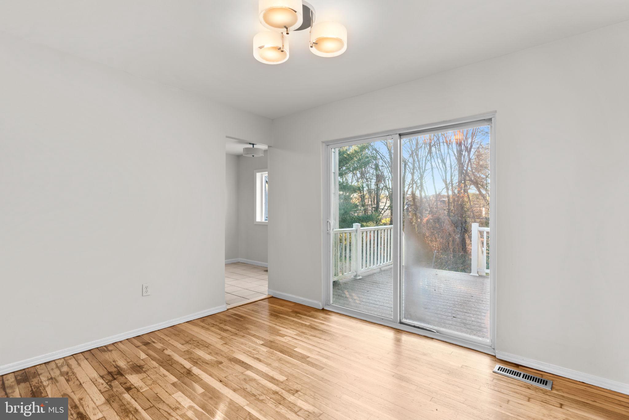 8111 Phirne Road East Glen Burnie, MD 21061 - Photo 6 of 30 a view of empty room with wooden floor and fan