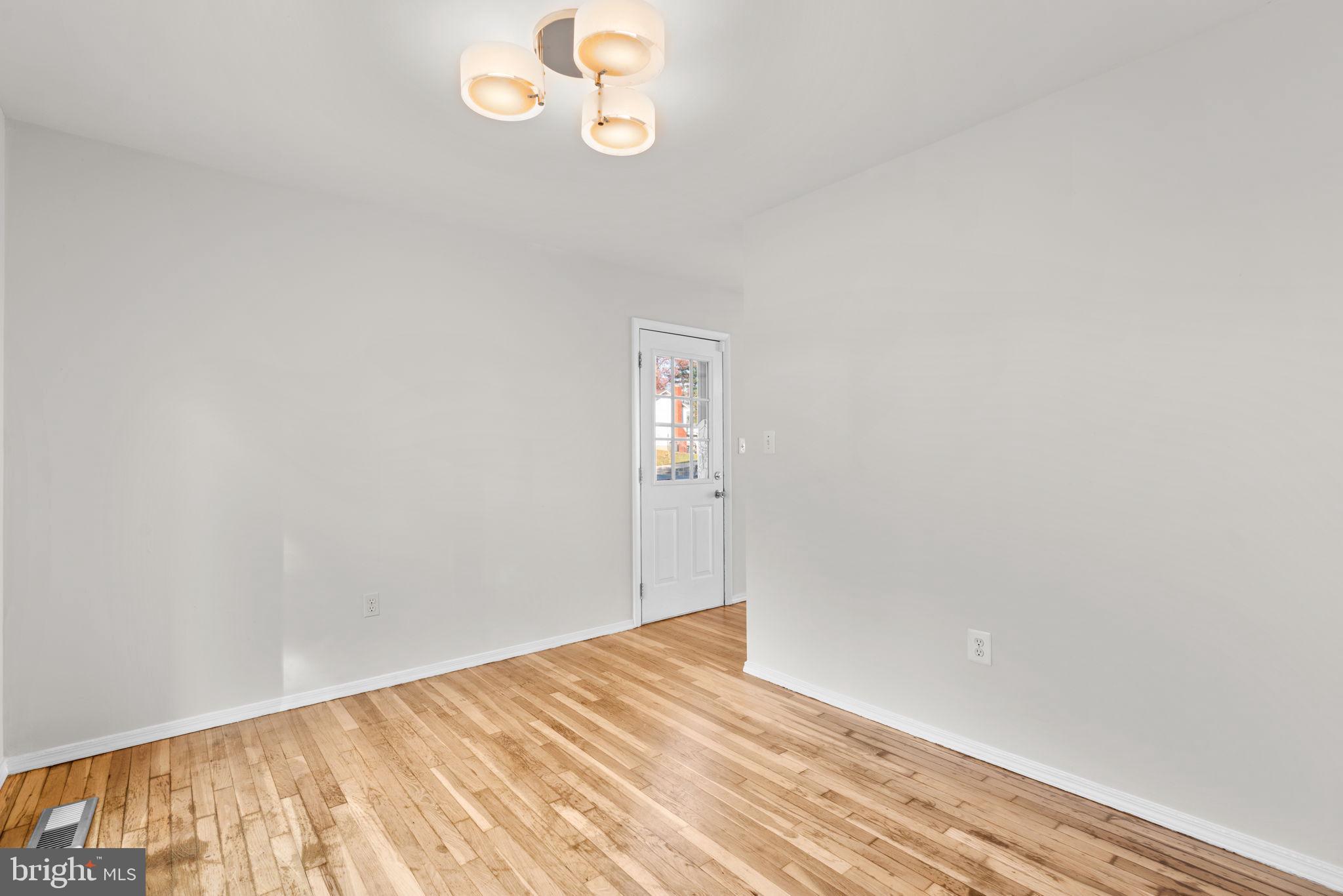 8111 Phirne Road East Glen Burnie, MD 21061 - Photo 7 of 30 a view of empty room with wooden floor